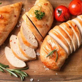 Cooked chicken breast on a cutting board