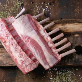 Uncooked rack of lamb on a cutting board